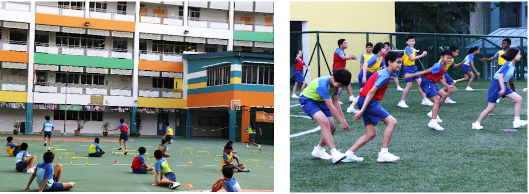 Children in colorful uniforms exercise outdoors at a school, one group on a court and another on a grass field.